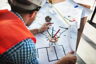 Person working on an architectural sketch